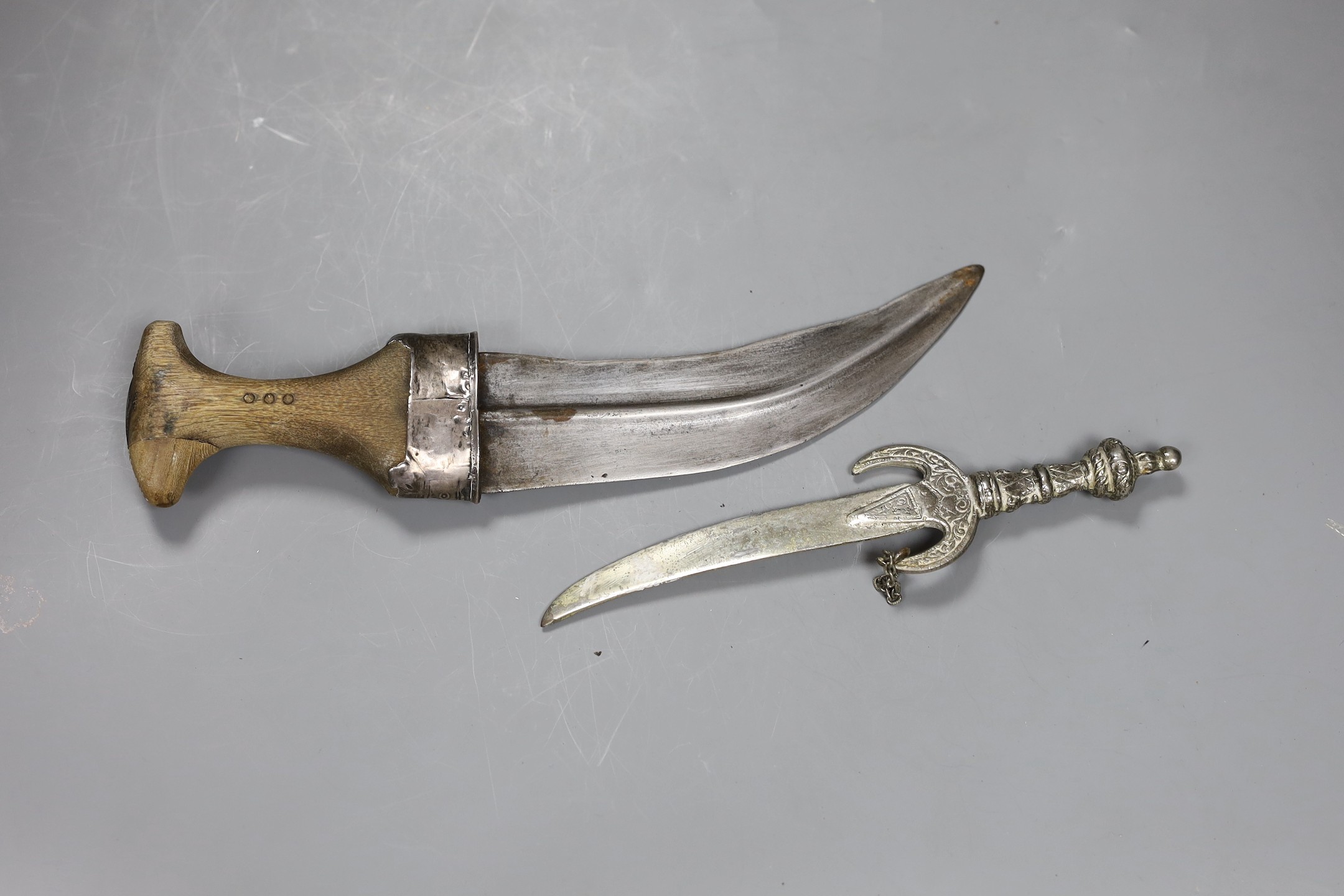 An Arab jambiya white metal dagger and one other ceremonial dagger